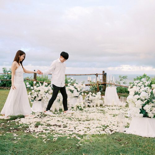 a bali proposal surrounded by white flowers